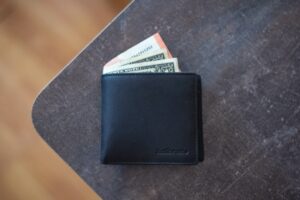Wallet with money on table.