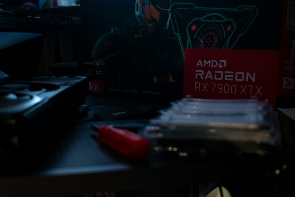 AMD Radeon RX 7900 XTX graphics card repair on motherboard with screwdriver