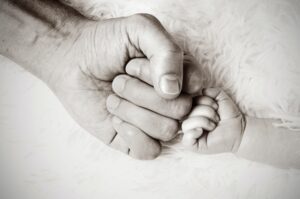 Father fist bumping baby.