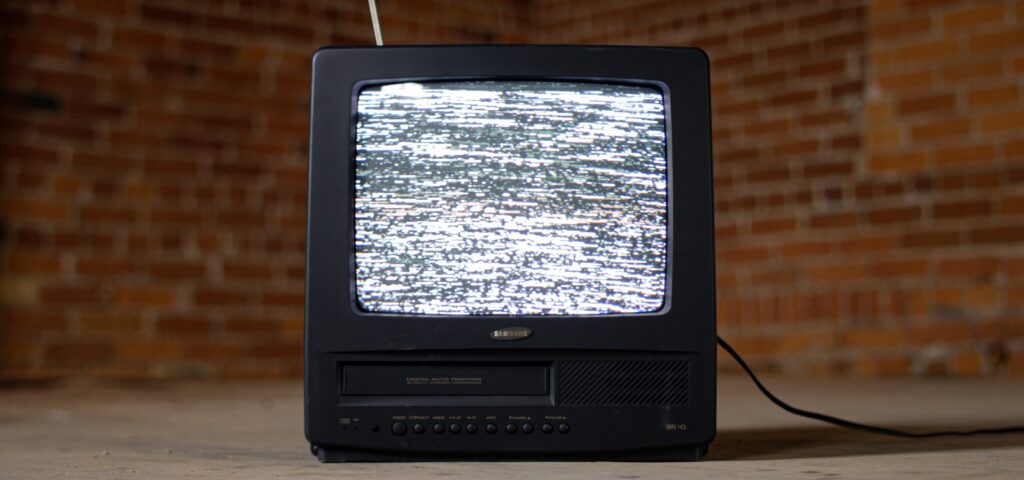 Old TV with static on the screen.