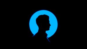 Blue profile picture of man in shadows.