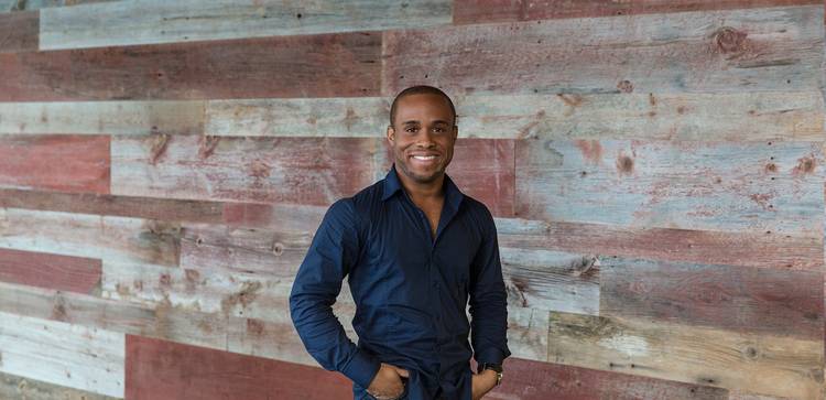 Stock photo of man standing against wood wall