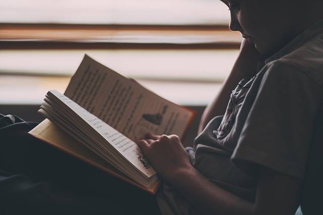 Kid reading book.