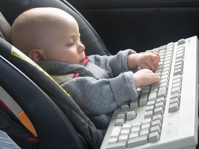 kid typing on keyboard