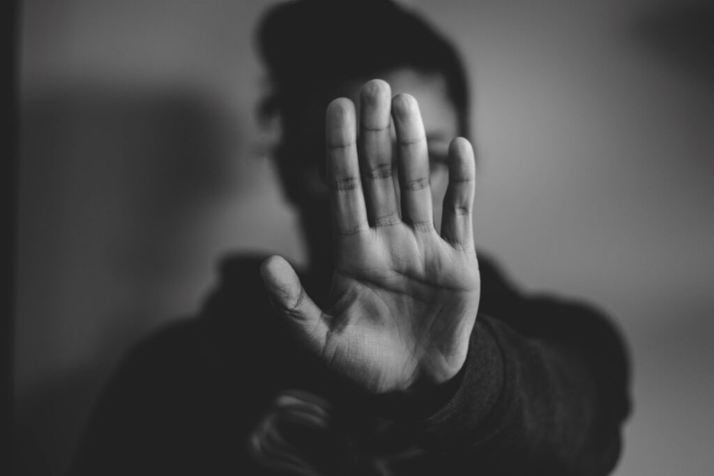 The person holding up their hand.