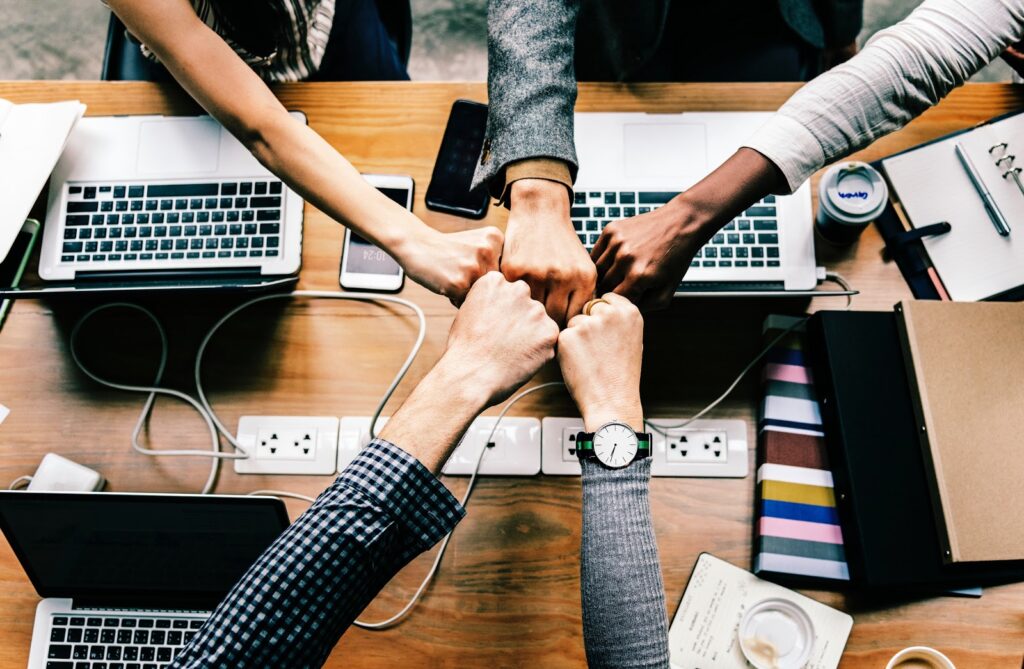 5-person fist bump after helping with remote computer repair