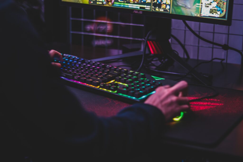 A person playing on their custom gaming computer.