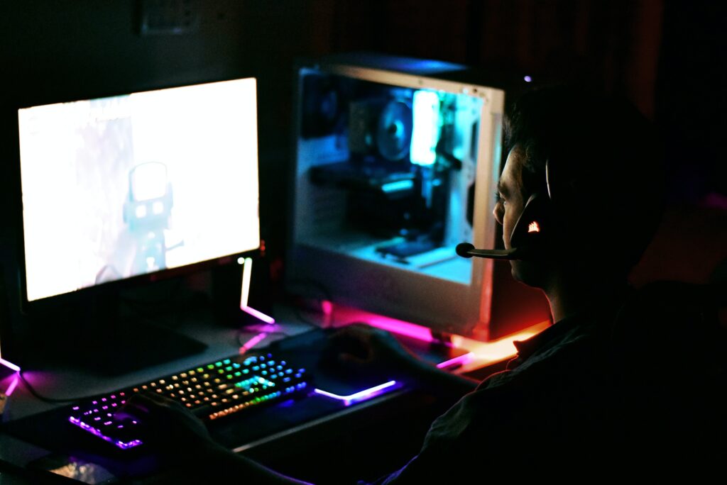 A man is playing his newly custom gaming computer.