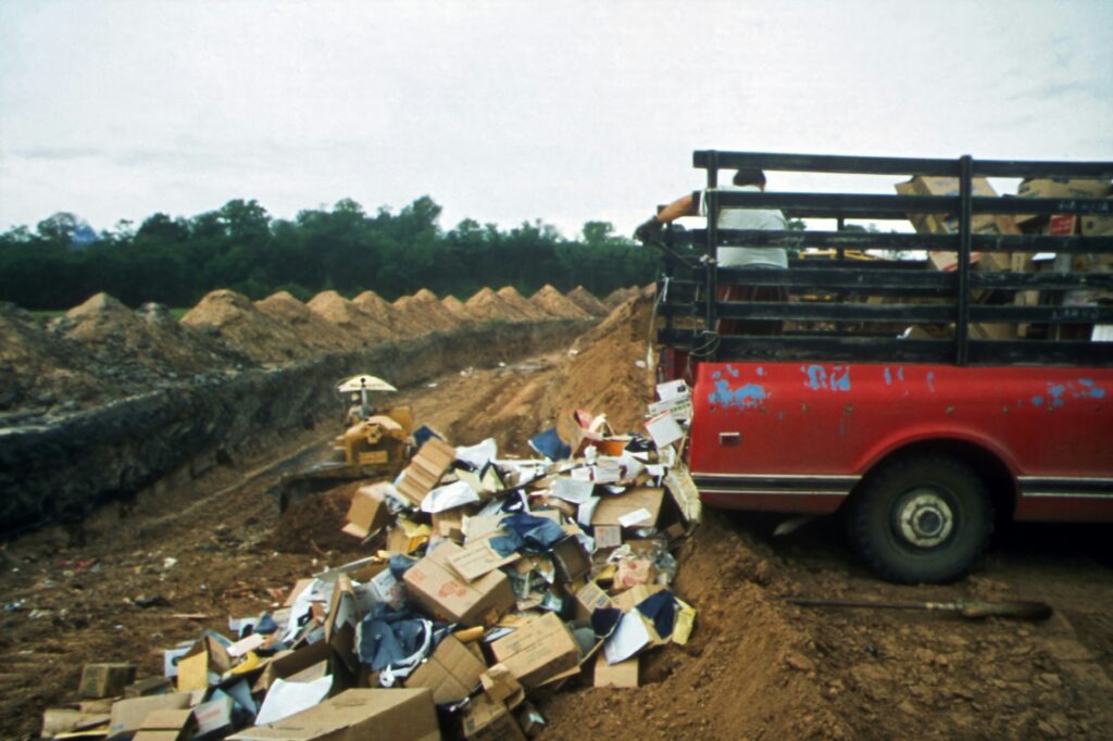 E-Waste Disposal: Truck dumps trash and other waste in landfill