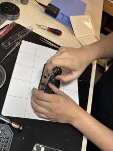 Mobile Repair: Tech working on a cell phone