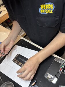 Mobile Device Repair: Tech working on iPhone