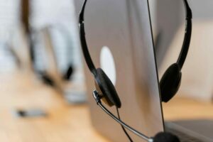 Remote Computer Support: A laptop with headset on top