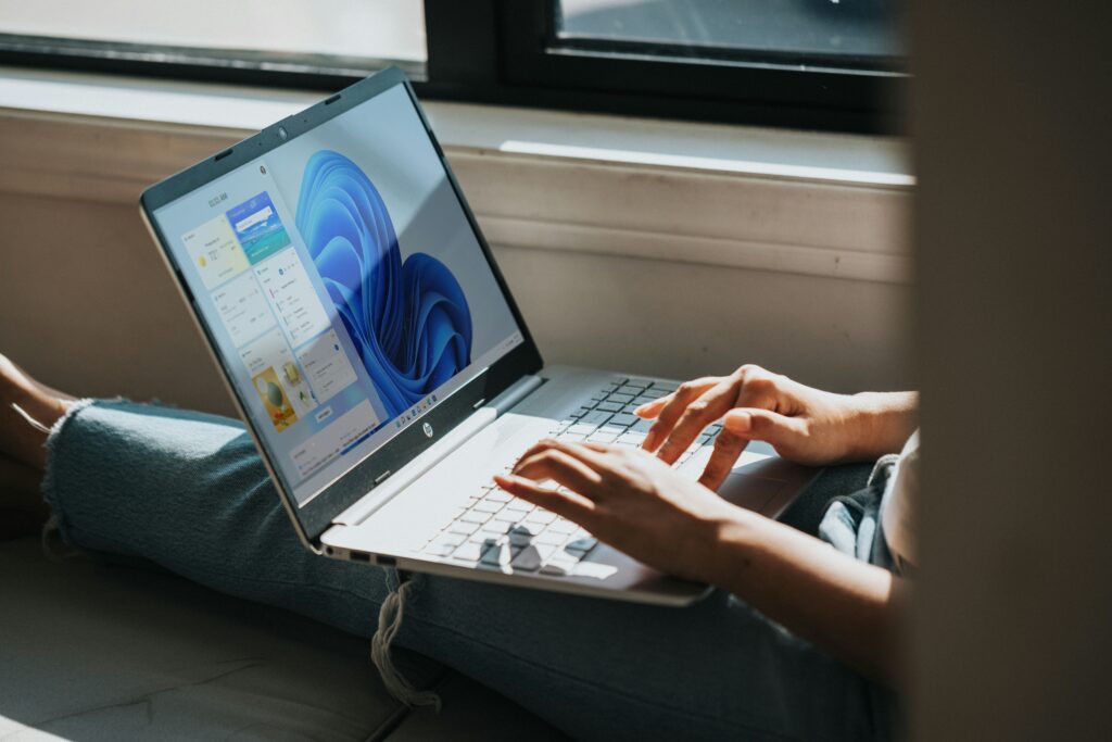 Woman working on a Windows based laptop.